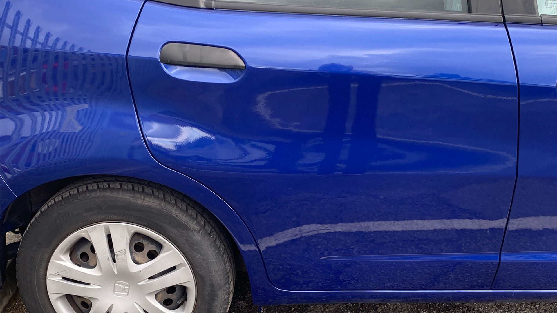 a cars rear driver side door with a freash new paint job aftewr being repaired by highfeild coachworks